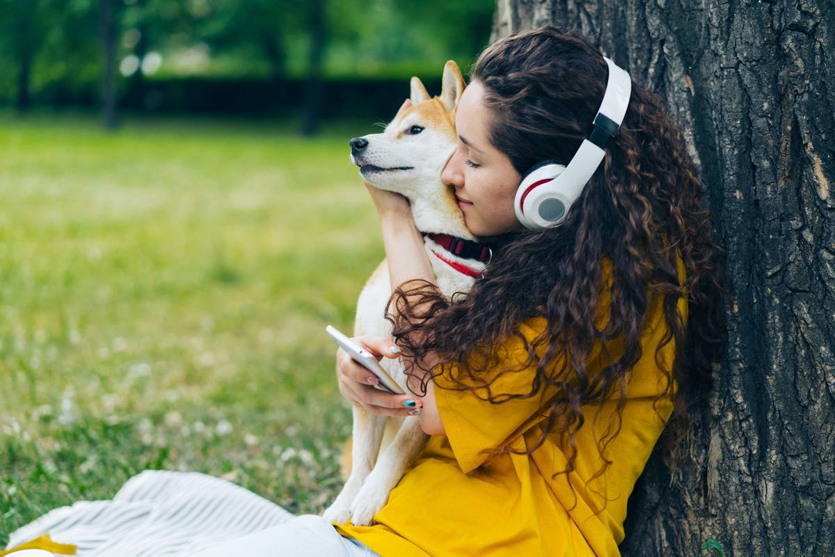 Happy family with their insured dog getting an ear exam at home